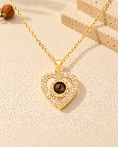 Vorderansicht der goldfarbenen Doppelherz-Kette mit Zirkonia und Bild im Stein