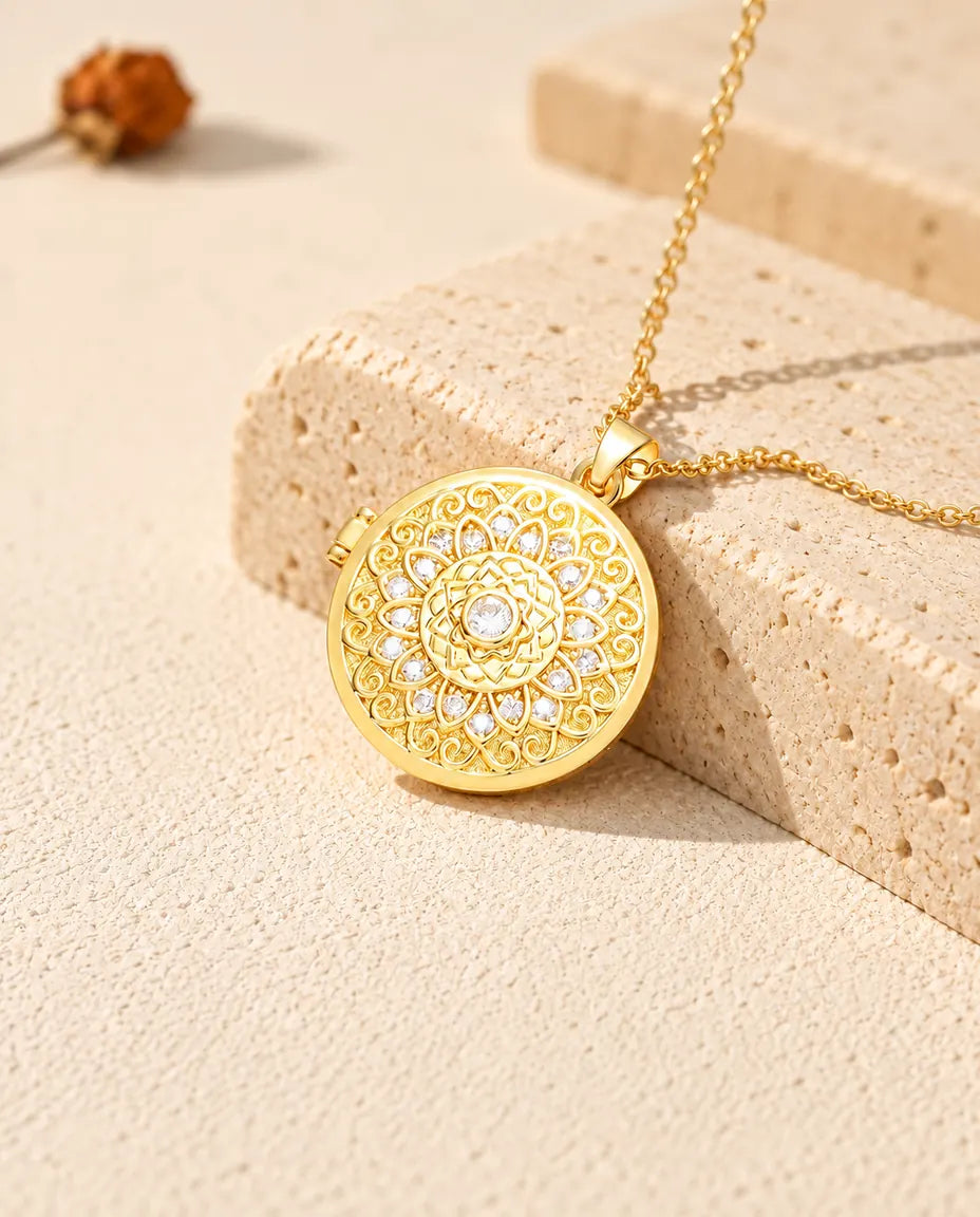 Goldfarbenes rundes Foto-Medaillon mit Mandala-Blume als Kette an einem Travertinblock